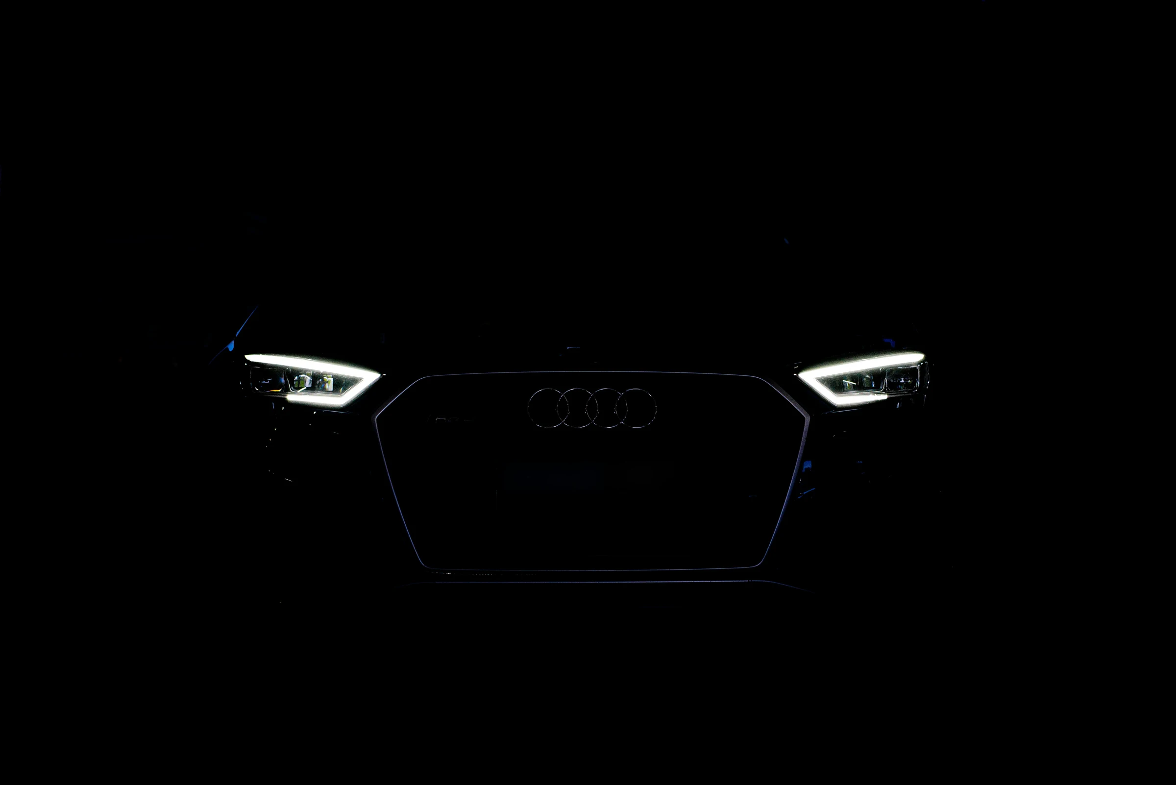 Audi front grille and LED headlights picked out in the dark